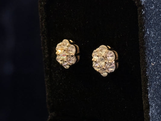 Pair of diamond earrings on a black velvet stand